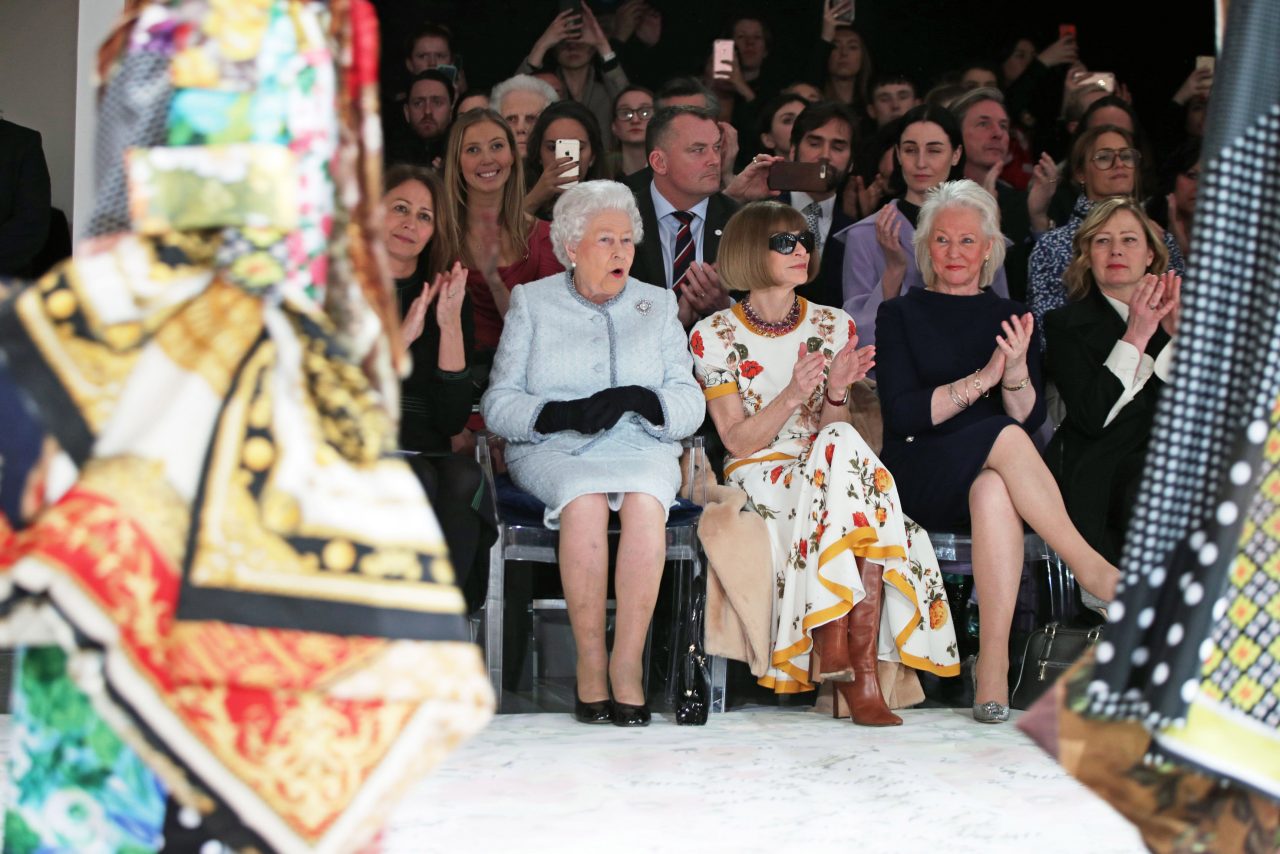 LONDON, ENGLAND - FEBRUARY 20: Queen Elizabeth II sits with Anna Wintour, Caroline Rush (L), chief executive of the British Fashion Council (BFC) and royal dressmaker Angela Kelly (R) as they view Richard Quinn