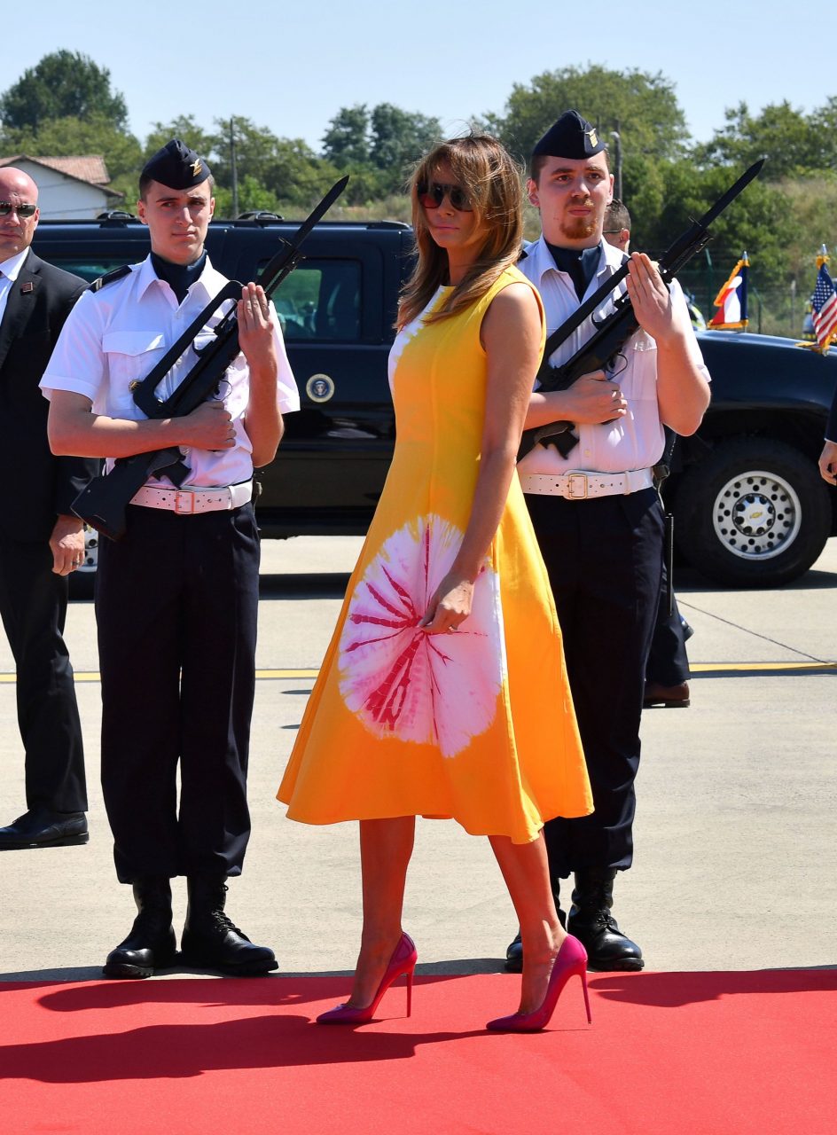 US President Donald Trump (2nd L) and First Lady Melania Trump (2nd R) walk past French airforce soldiers after disembarking from an airplane upon landing at the Biarritz Pays Basque Airport in Biarritz, south-west France, on August 24, 2019, on the first day of the annual G7 Summit attended by the leaders of the world