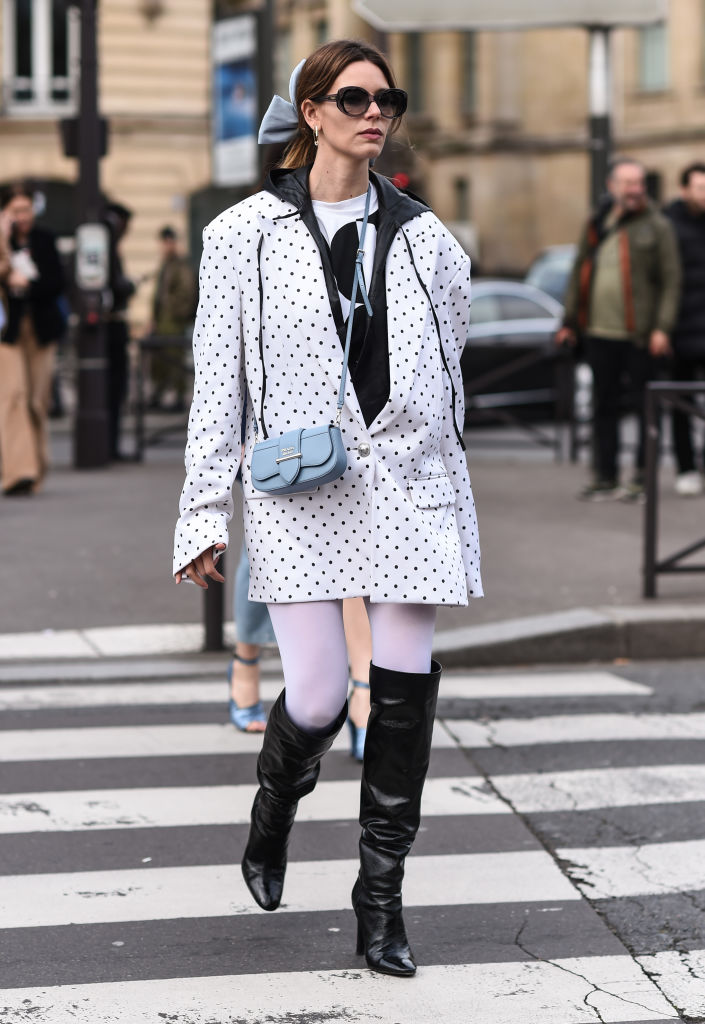 PARIS, FRANCE - MARCH 03: A guest is seen wearing a white polka dot jacket and Prada purse outside the Miu Miu show during Paris Fashion Week: AW20 on March 03, 2020 in Paris, France. (Photo by Daniel Zuchnik/Getty Images)