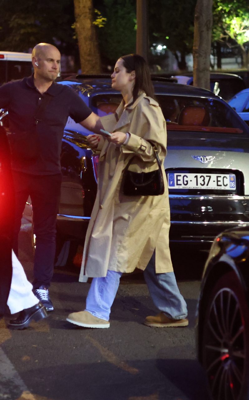 <strong>June 14, 2023</strong> spotted wearing a beige trench coat, light wash straight-leg jeans and UGG boots in Paris, France
