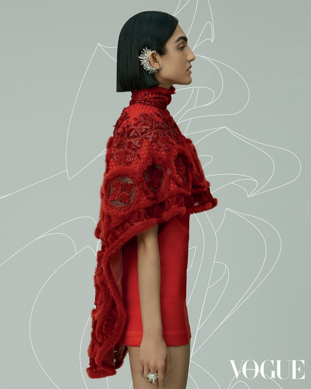 Cape, dress, ear cuff and ring, all Fendi Couture.